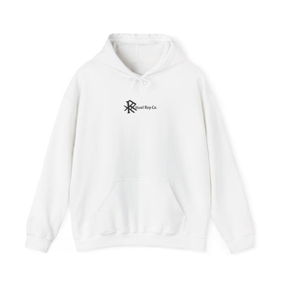 Flat lay of white Initiate Hoodie with black Ritual emblem over heart